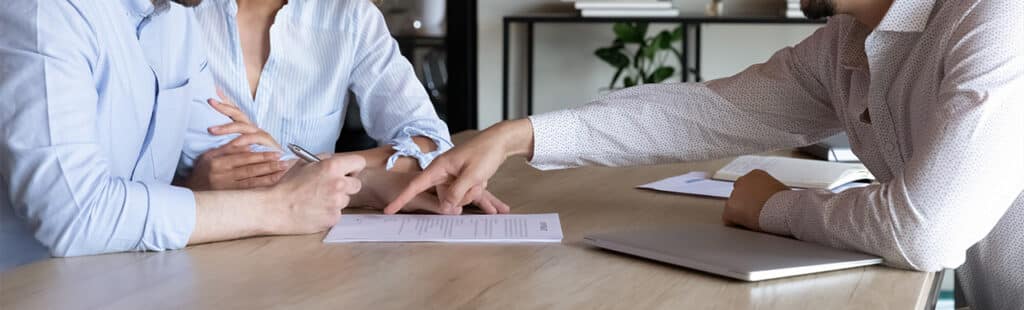 man signing documents