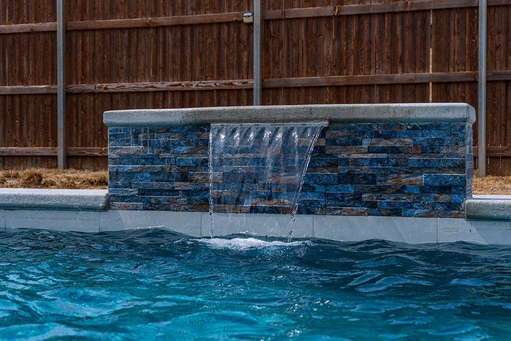 Waterfall feature in a pool